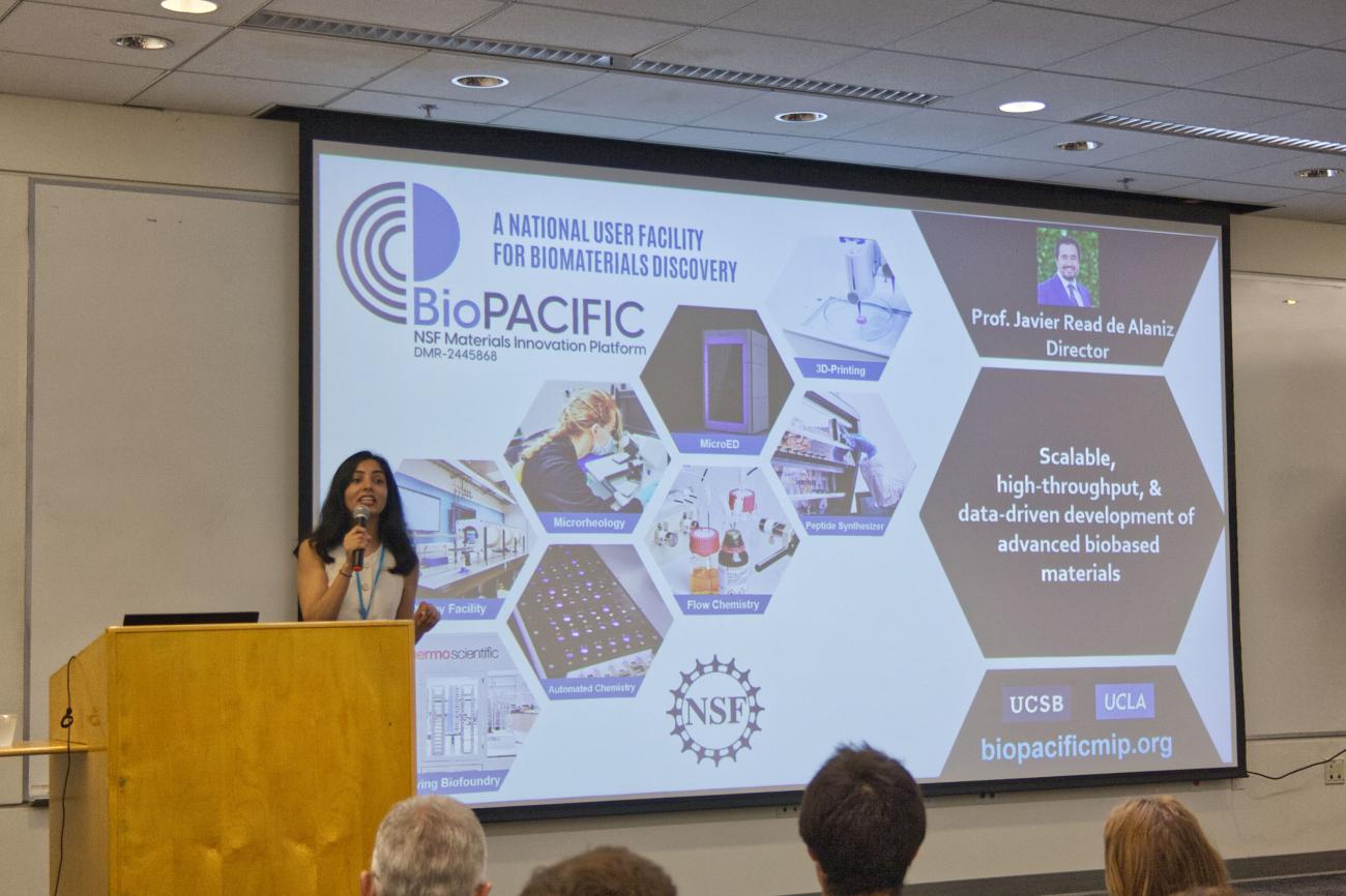 Komal Standing by Podium